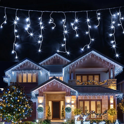 Jingle Jollys Solar Icicle Lights, 960 LED, Cool White, 32 m, lit up in the dark
