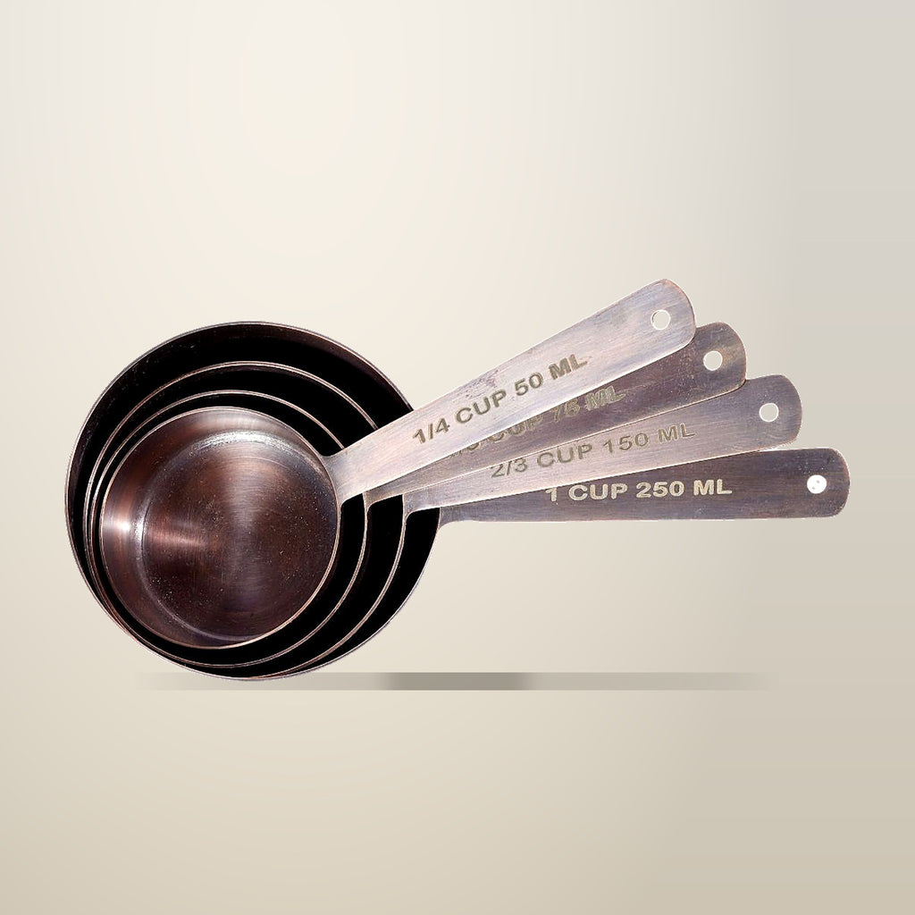 Antique Copper Finish Stainless Steel Measuring Cups, Set of 4, on a plain cream background