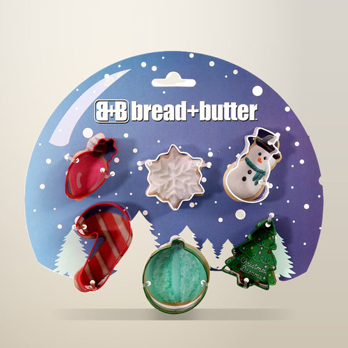 Bread and Butter Christmas Cookie Cutters, Globe, Flake, Snowman, Cane and Sock, on a plain cream background