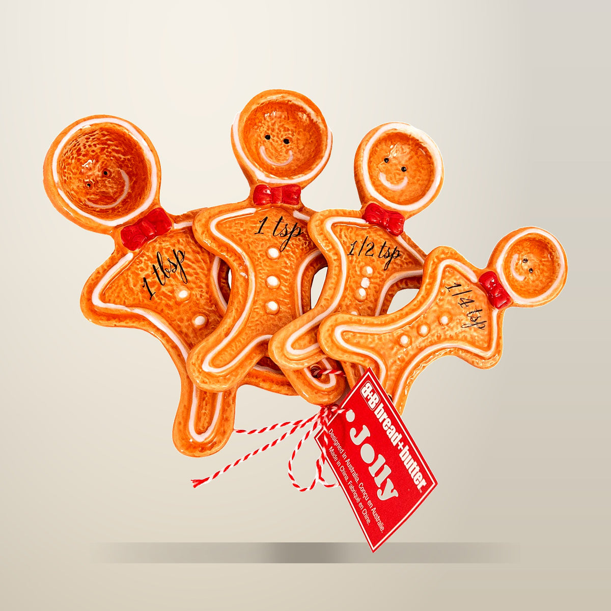 Bread and Butter Gingerbread Man Measuring Spoons, on a plain cream background