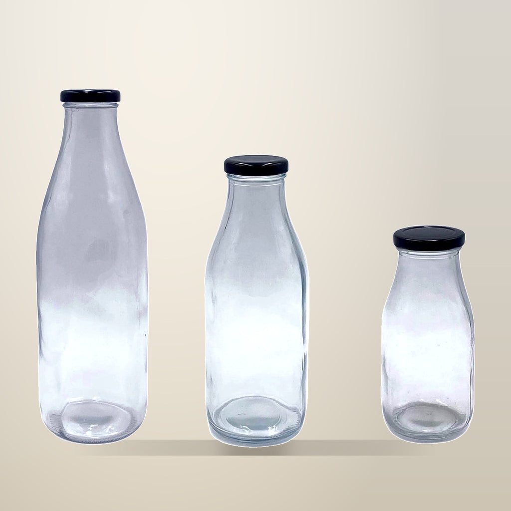 Glass Milk Bottles with Metal Lids, 500 ml, 24 Pack, on a plain cream background