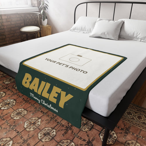 Personalised pet photo blanket laid on a bed, with a dog or cat photo, the pet's name and Merry Christmas
